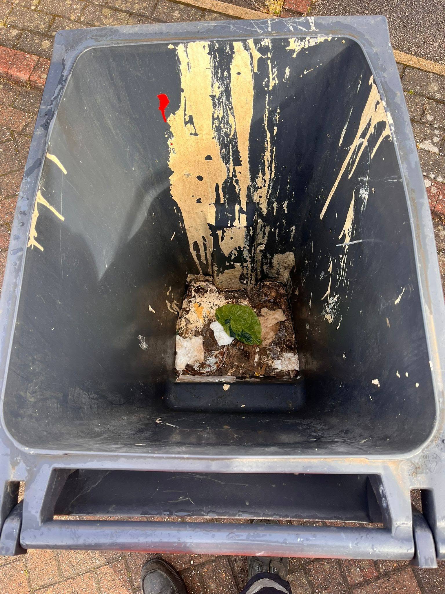 Wheelie bin interior with heavy grime before cleaning