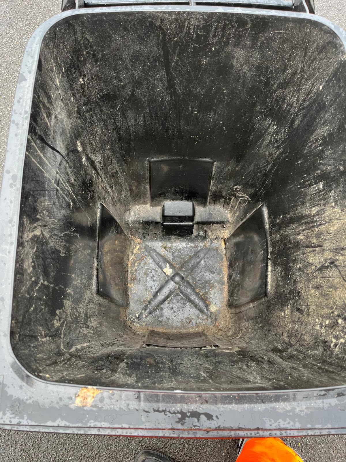 Wheelie bin interior with rubbish before cleaning